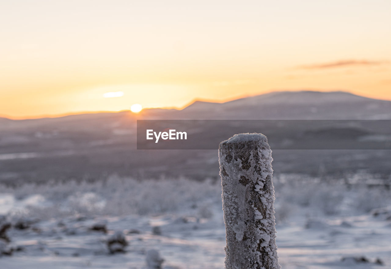 sunset, winter, snow, sky, scenics - nature, nature, environment, cold temperature, beauty in nature, landscape, mountain, tranquility, no people, tranquil scene, sun, horizon, sea, ice, sunlight, cloud, dawn, water, frozen, outdoors, focus on foreground, land, fog, rock, idyllic, non-urban scene, wave, freezing, twilight, travel destinations, post