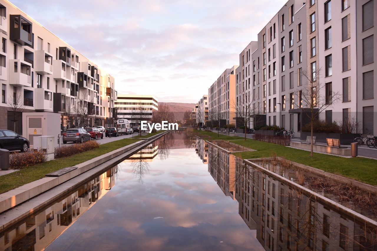 Reflection of buildings in puddle on street