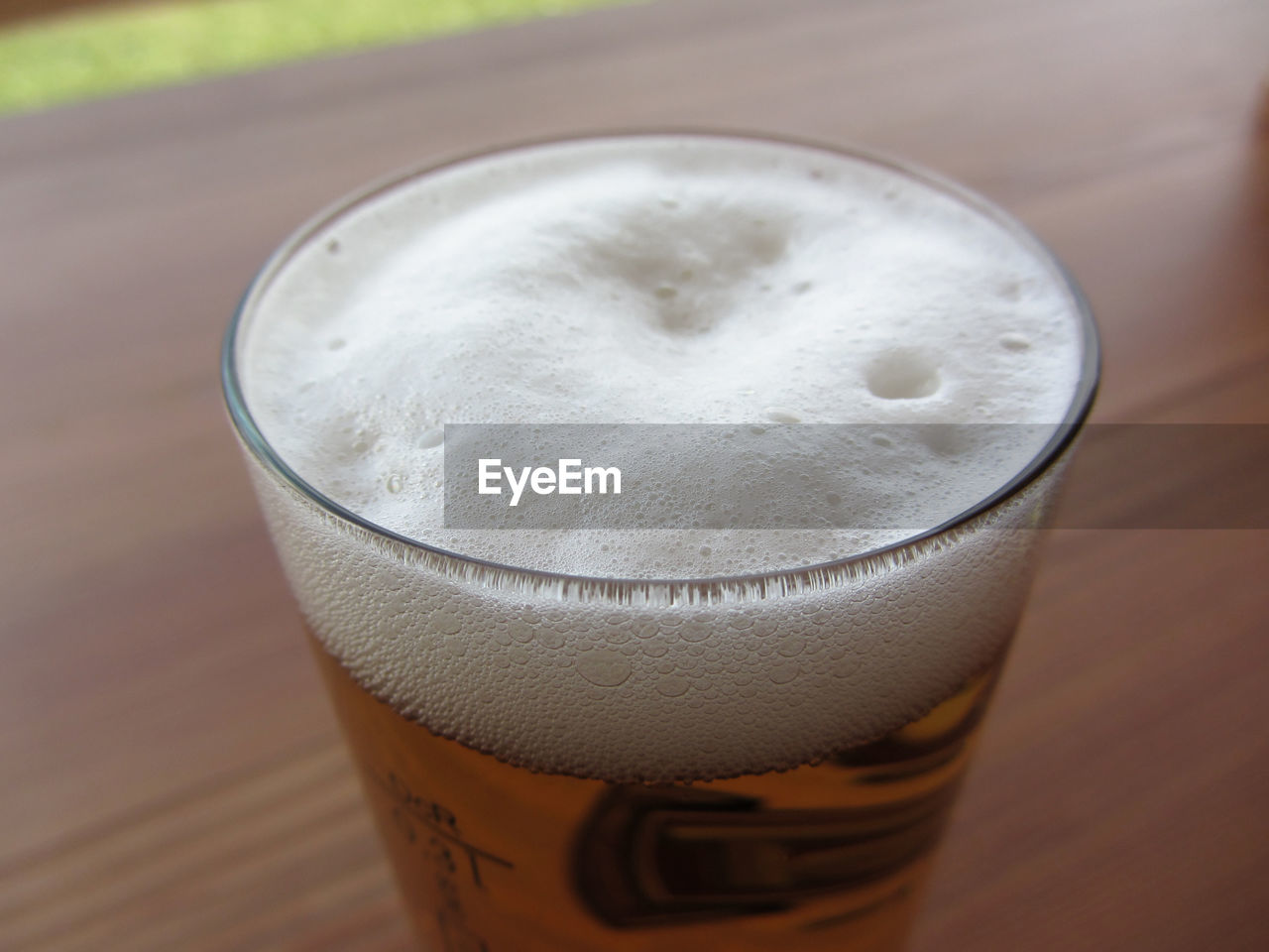 Glass of beer on the table . beer foam closeup
