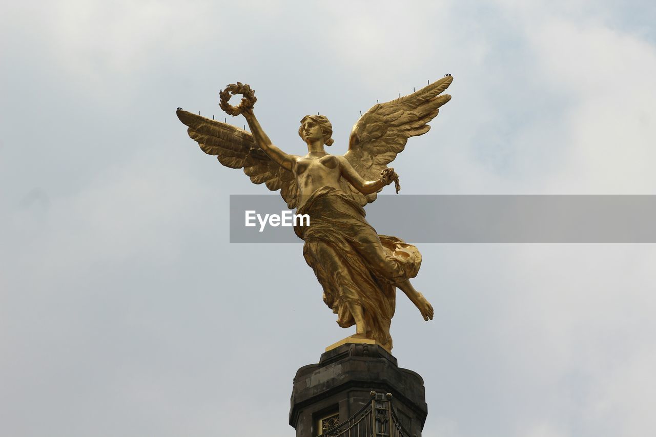 Low angle view of angel of independence against sky