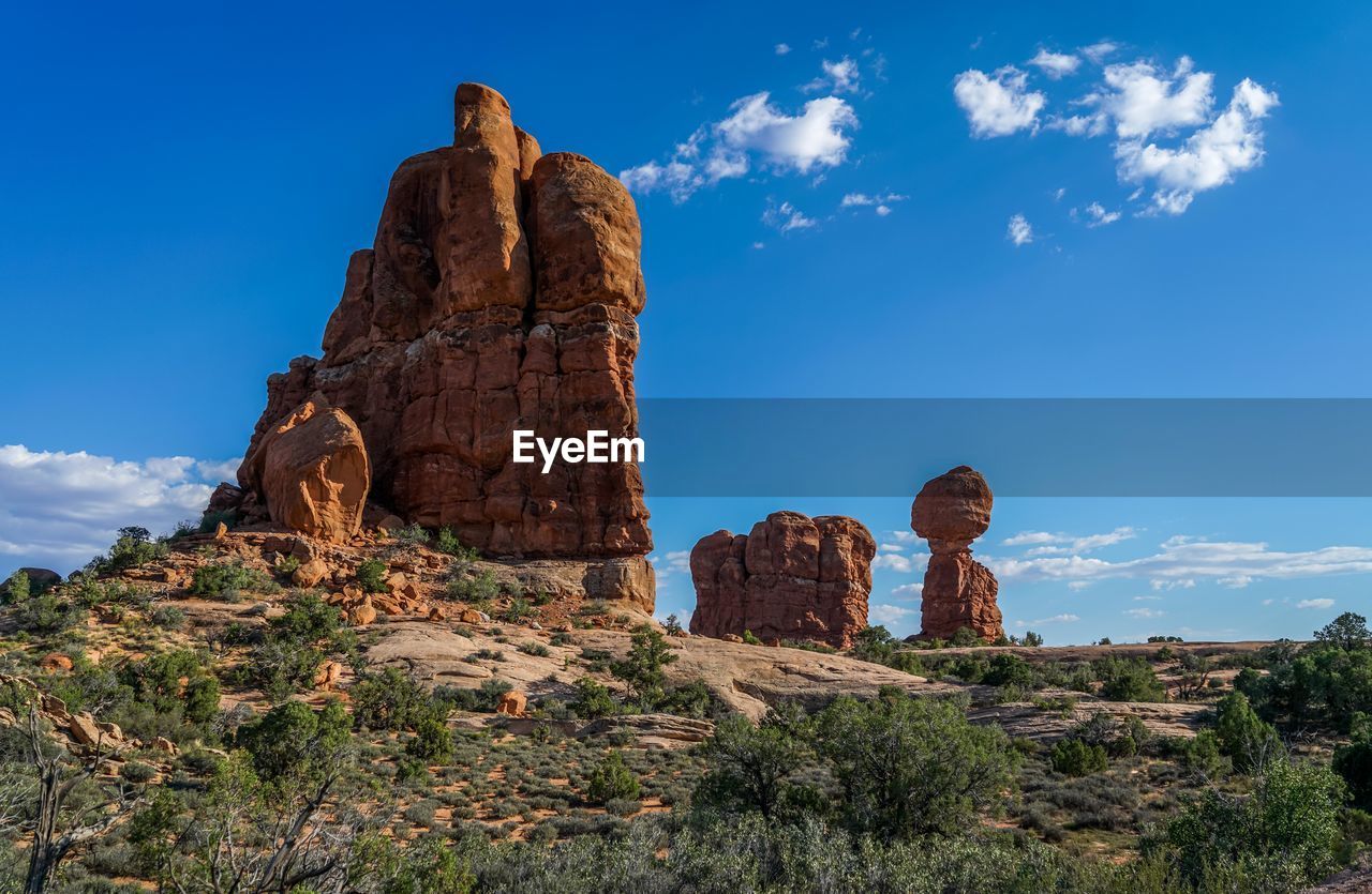 LOW ANGLE VIEW OF ROCK FORMATIONS AGAINST CLOUDY SKY