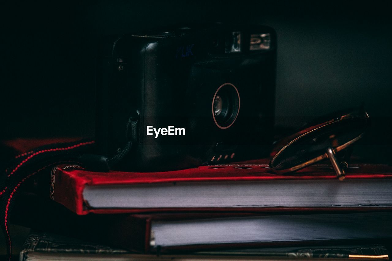 Close-up of sunglasses and camera on diary