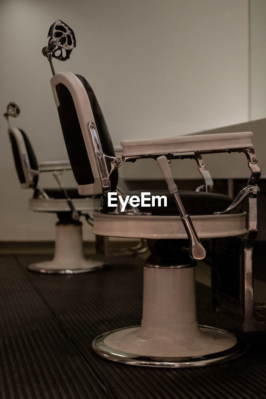 Empty barber chairs in salon