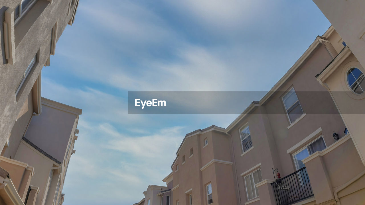 architecture, building exterior, built structure, building, sky, low angle view, window, residential district, city, facade, cloud, nature, no people, house, neighbourhood, apartment, day, outdoors, blue