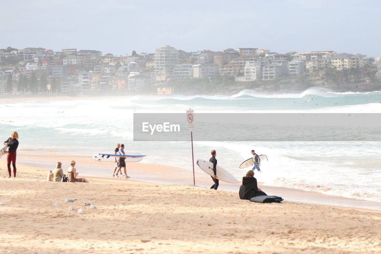 People at beach in city