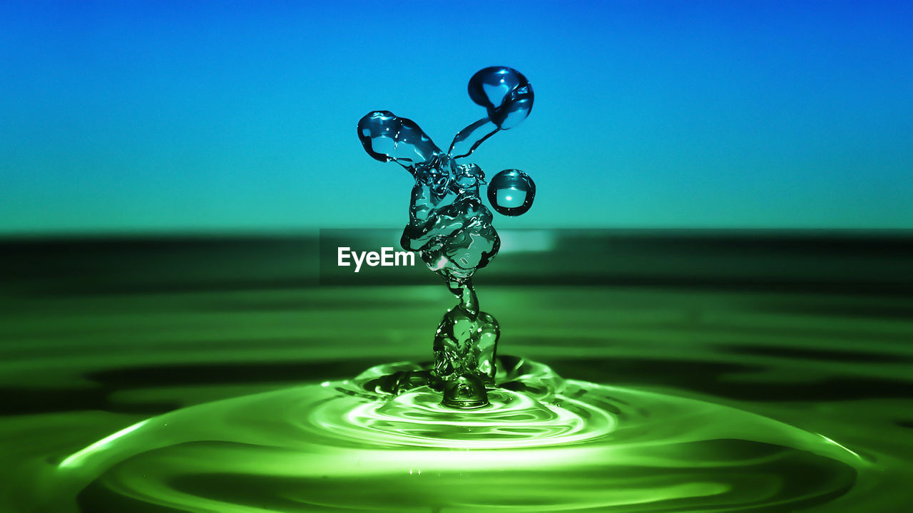 CLOSE-UP OF RIPPLED WATER IN BLUE BACKGROUND