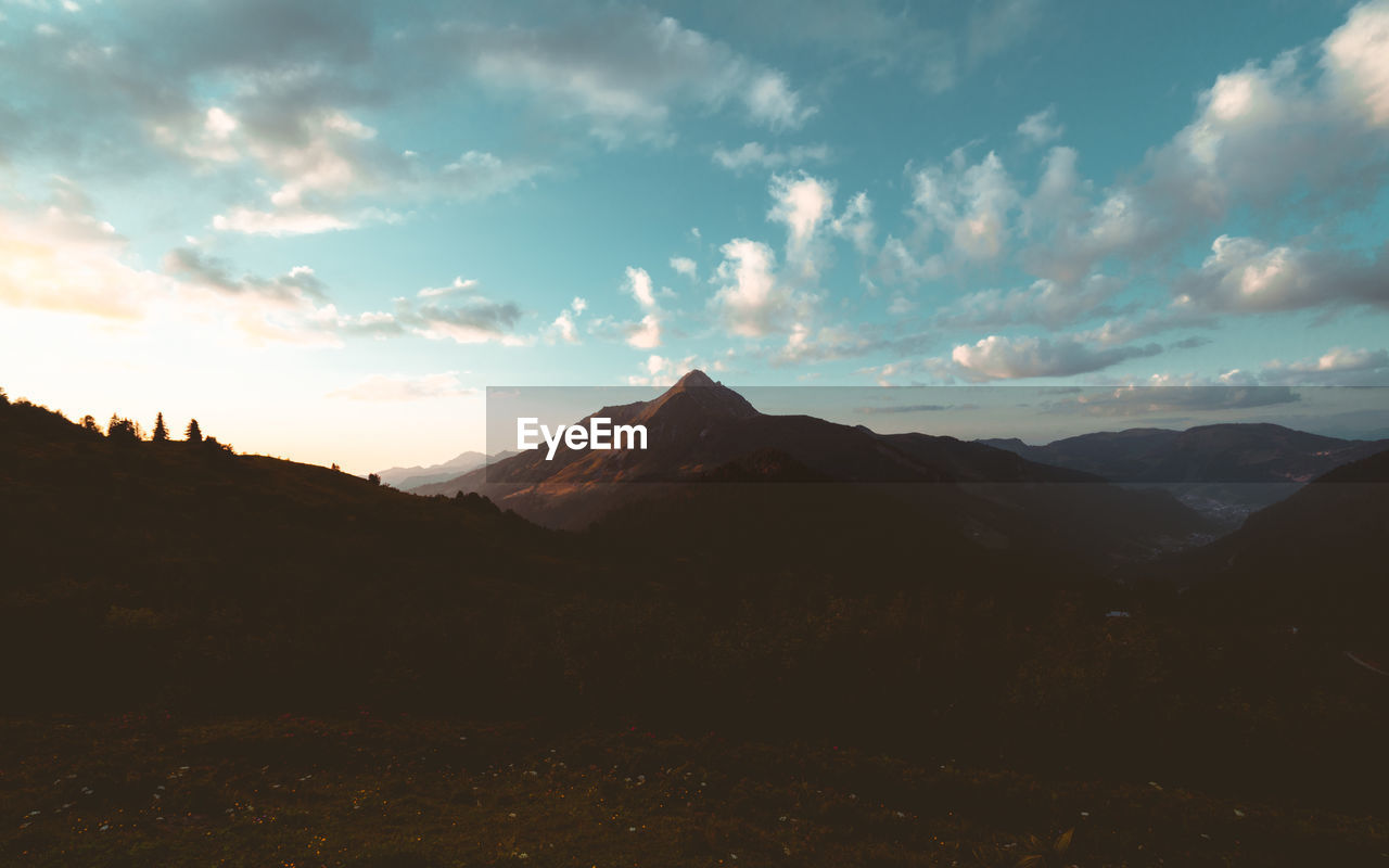 Scenic view of mountains against sky during sunset