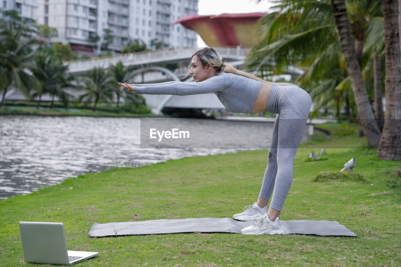 low section of woman exercising on field