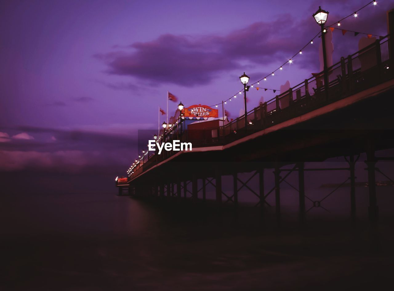 LOW ANGLE VIEW OF BRIDGE OVER RIVER AGAINST SKY