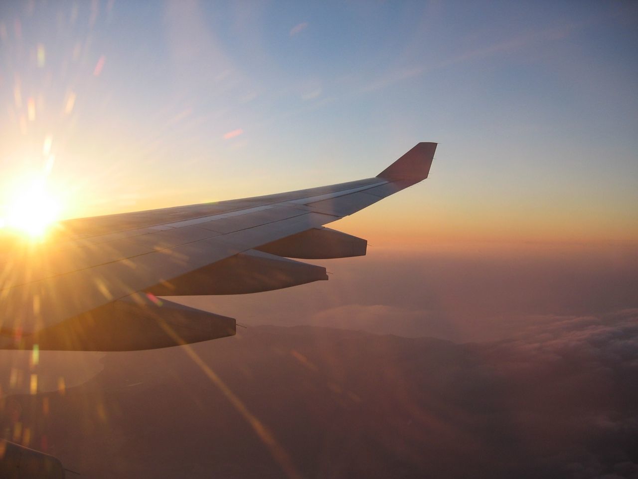 CROPPED IMAGE OF AIRPLANE FLYING OVER SKY