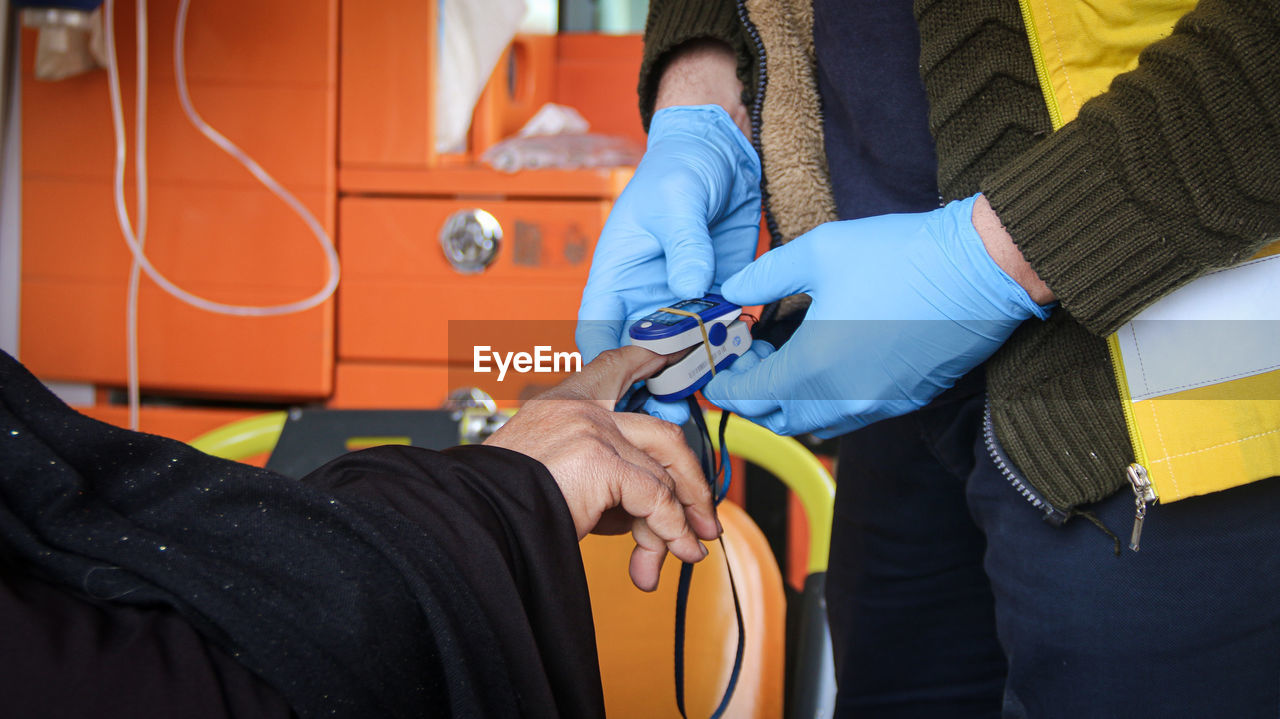A nurse embraces a child and treating him inside the ambulance