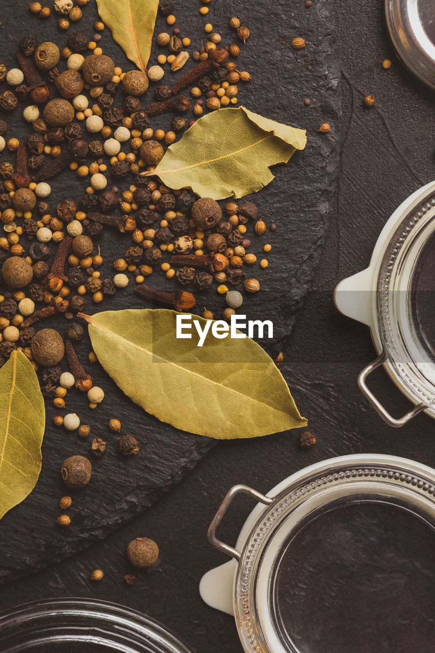 HIGH ANGLE VIEW OF COFFEE CUP WITH LEAVES