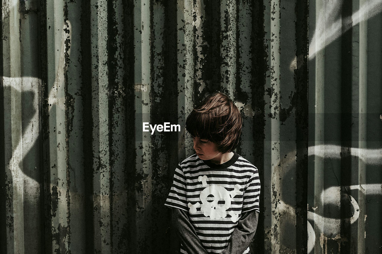 Boy standing against wall