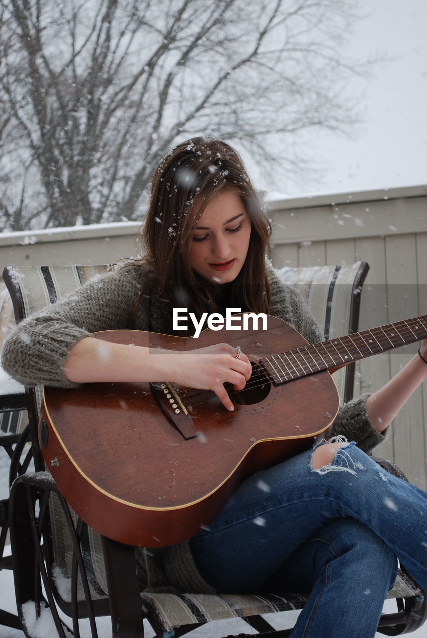 Young woman playing guitar