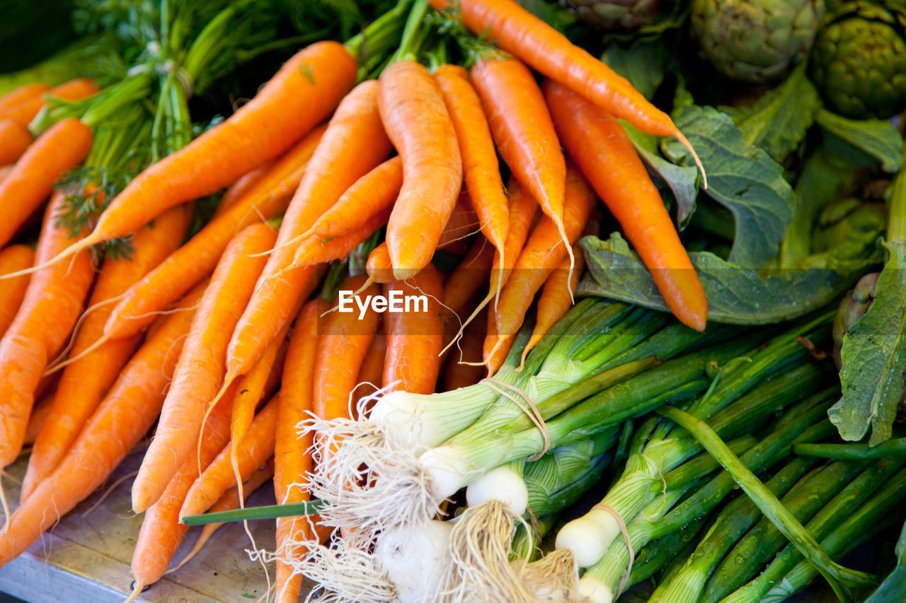Close-up of scallions and carrots at market