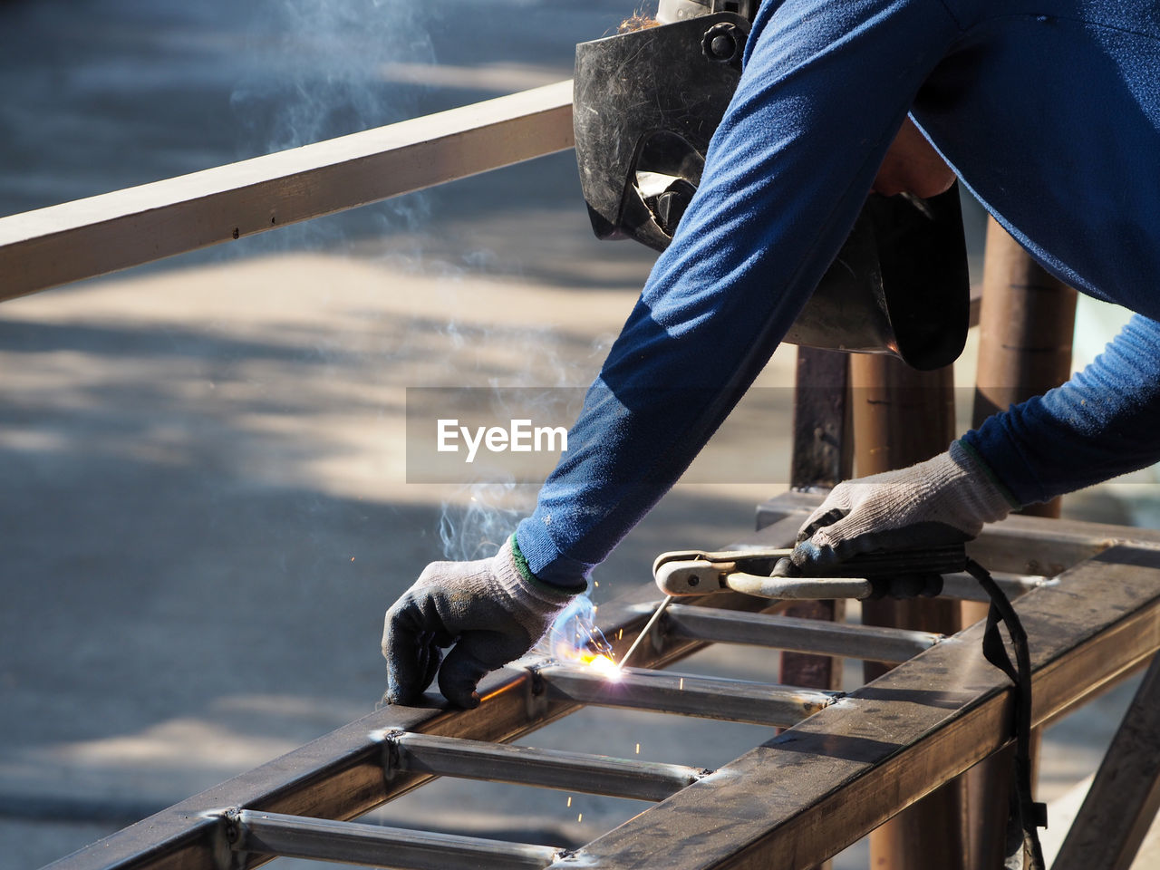 Man on welding metal at workshop