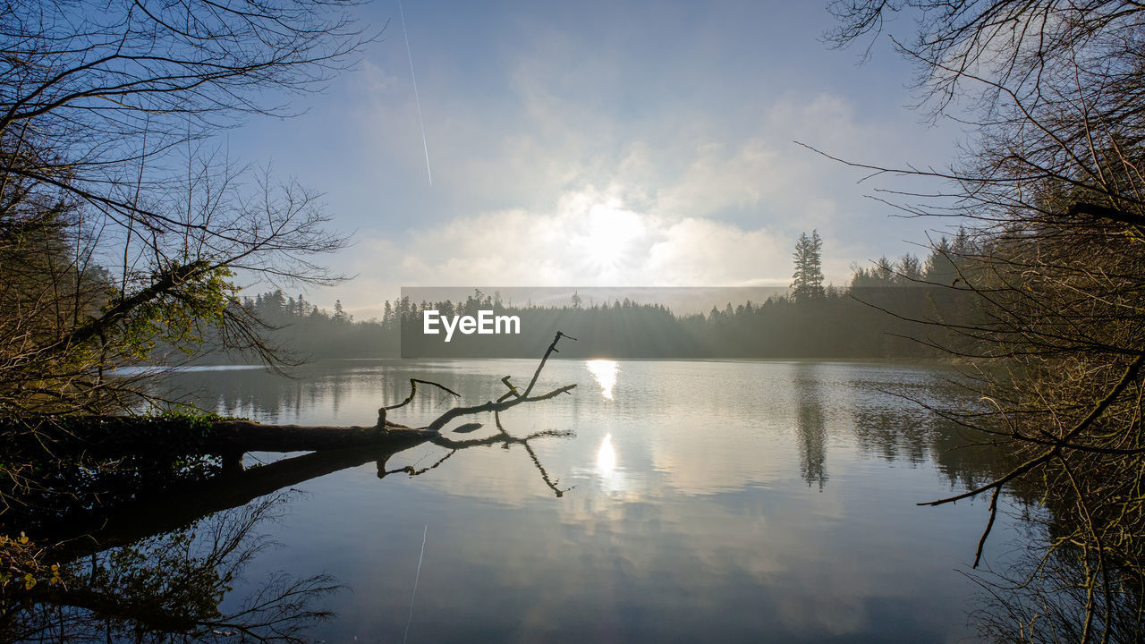 Scenic view of lake against sky during foggy weather