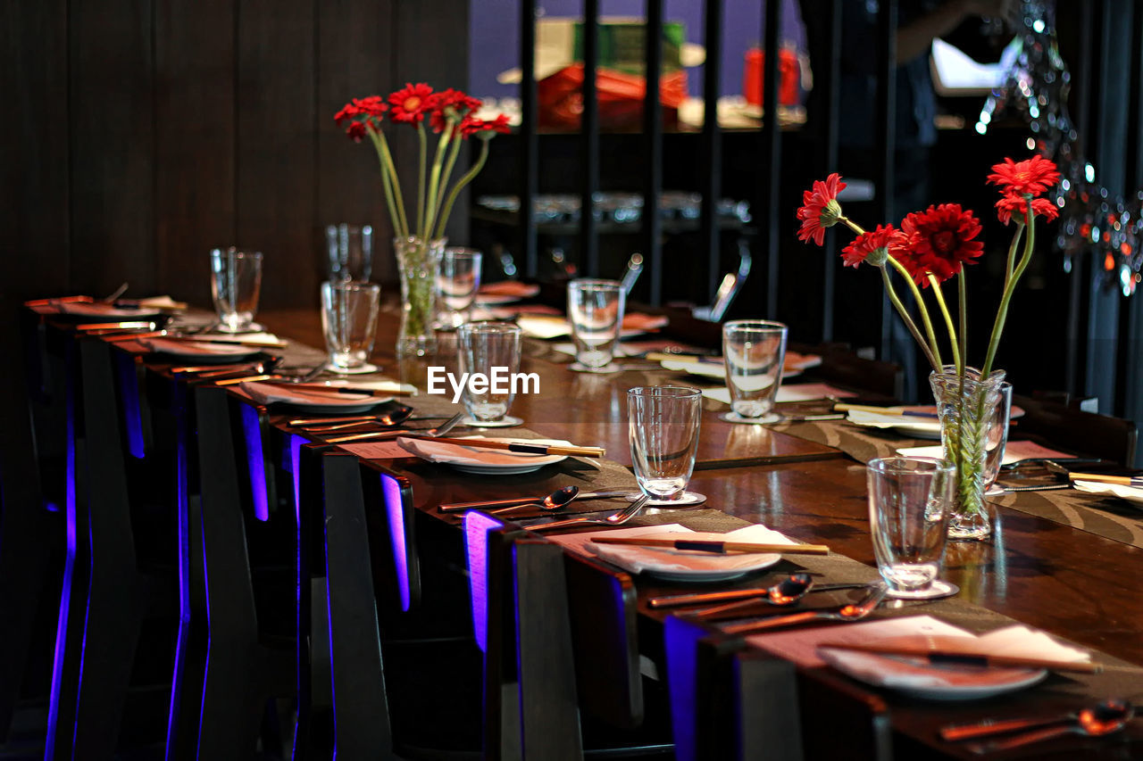 FLOWER POTS ON TABLE IN RESTAURANT