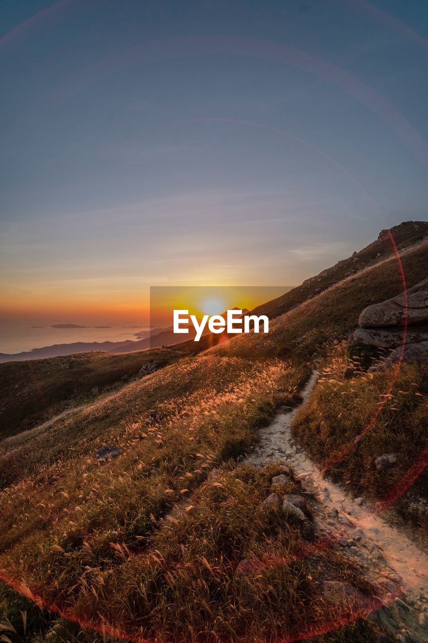 Scenic view of field against sky during sunset