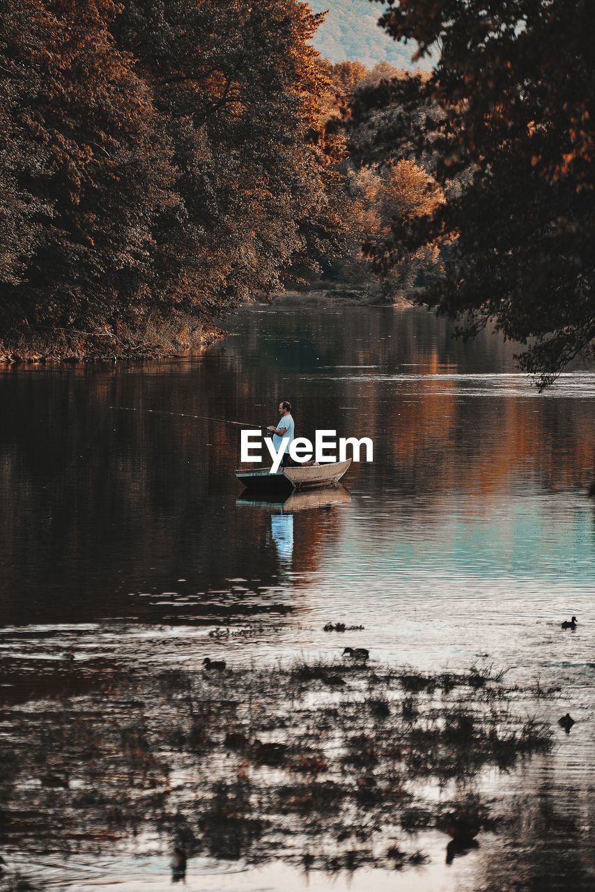 SCENIC VIEW OF LAKE AGAINST TREES