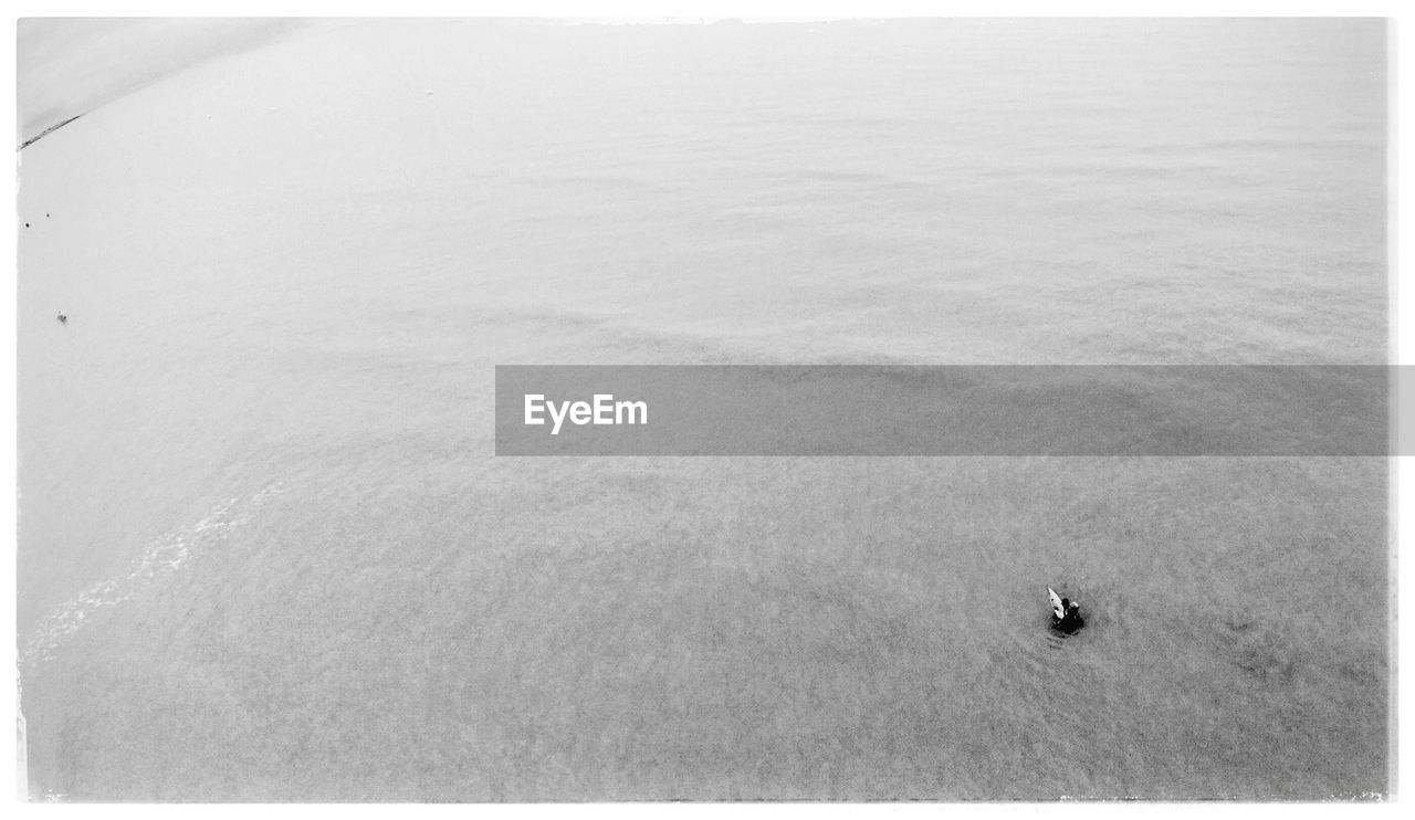 HIGH ANGLE VIEW OF NAUTICAL VESSEL IN SEA