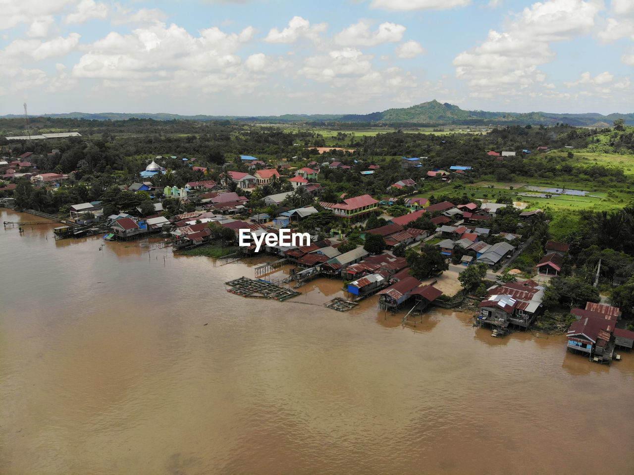 High angle view of townscape by river against sky