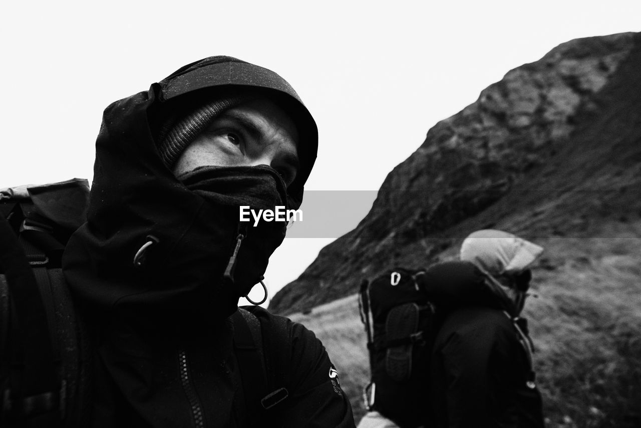 Close-up of men in mask against mountain during winter