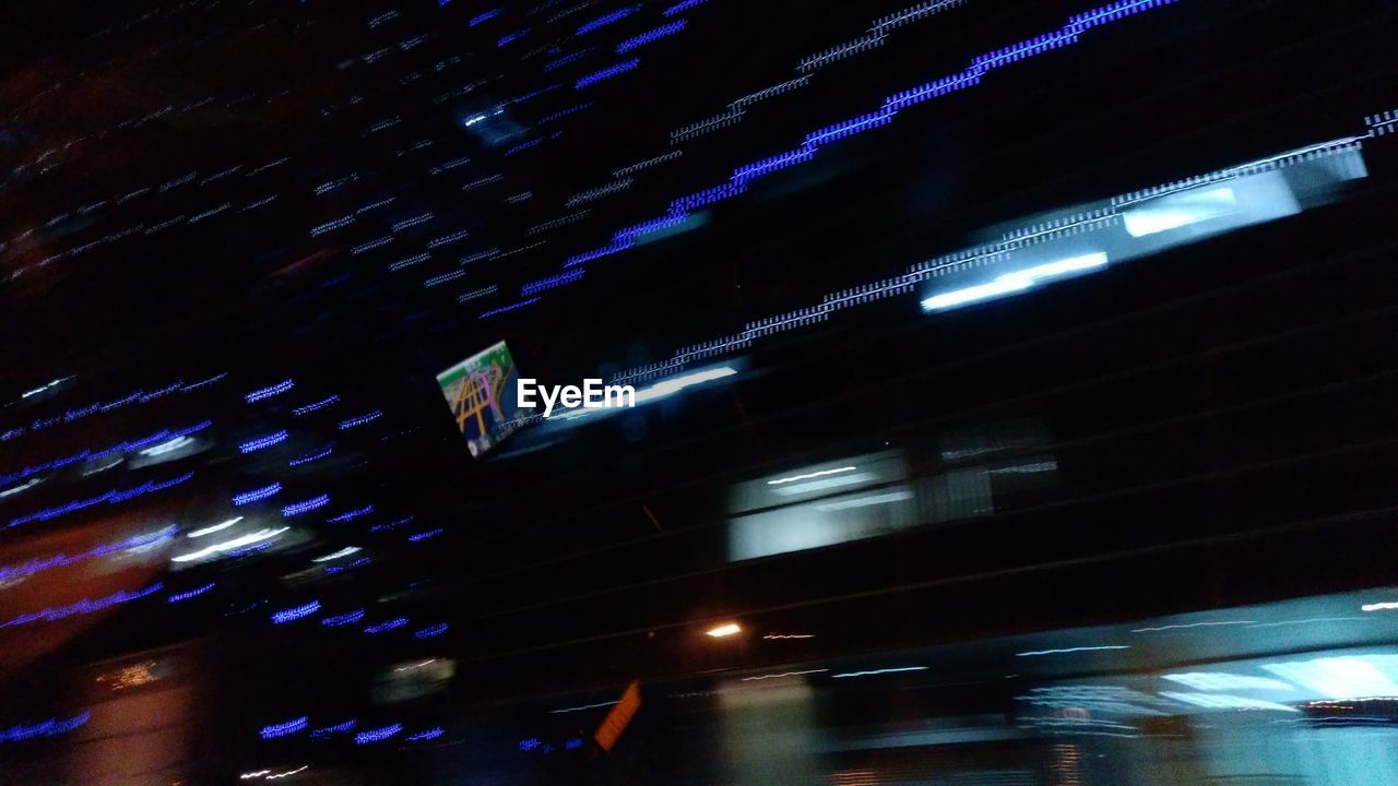 LOW ANGLE VIEW OF ILLUMINATED BUILDINGS IN CITY