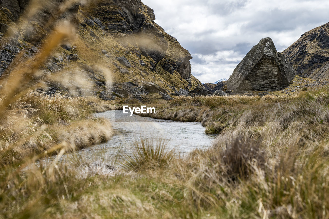 Rugged alpine landscape with a stream and rocks in new zealand