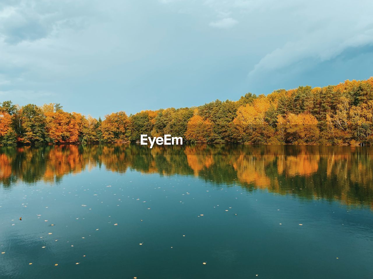 Reflection of trees in lake against sky during autumn