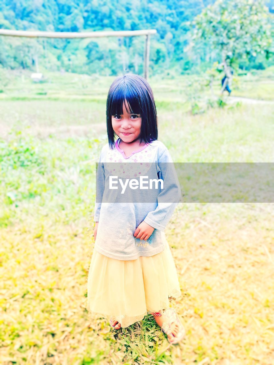 Portrait of cute girl standing on land