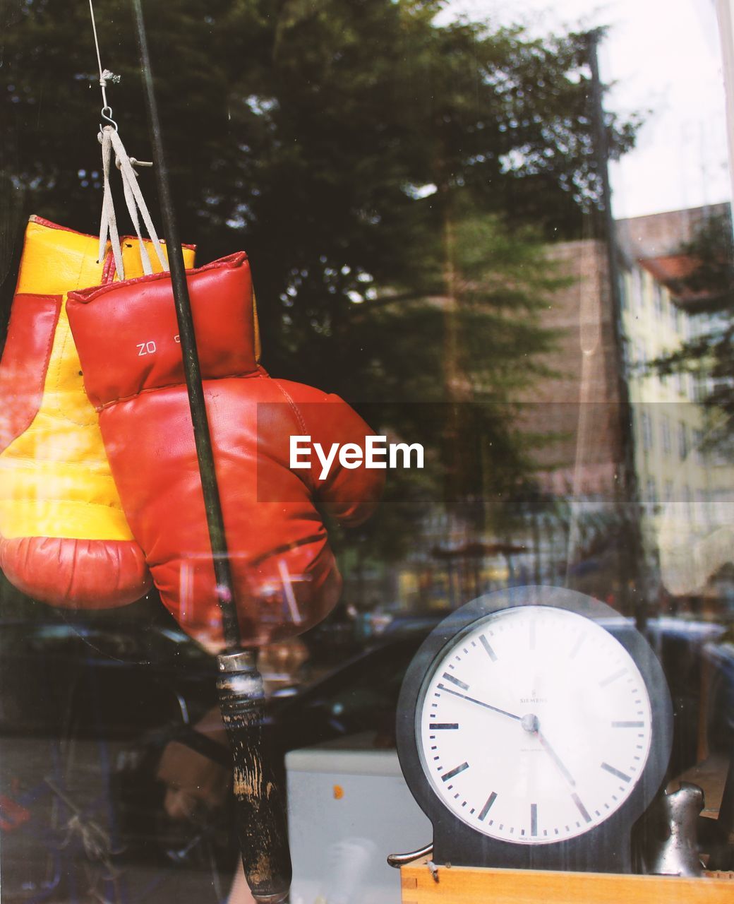 Boxing gloves and clock at store window