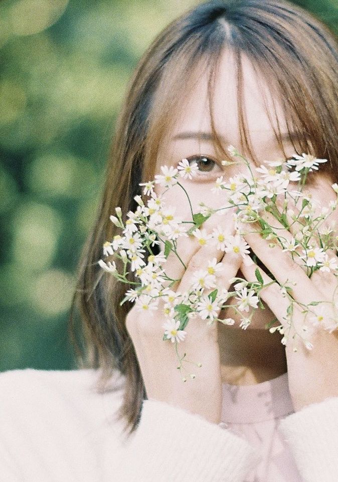 one person, portrait, women, female, headshot, plant, bride, flower, flowering plant, child, childhood, nature, wedding dress, looking at camera, adult, hairstyle, clothing, person, dress, fashion accessory, emotion, outdoors, day, close-up, front view, human face, holding, looking, young adult, beauty in nature, brown hair, focus on foreground, celebration, happiness, spring, long hair, lifestyles, white, event, blond hair, innocence, human head, pink, cute, smiling