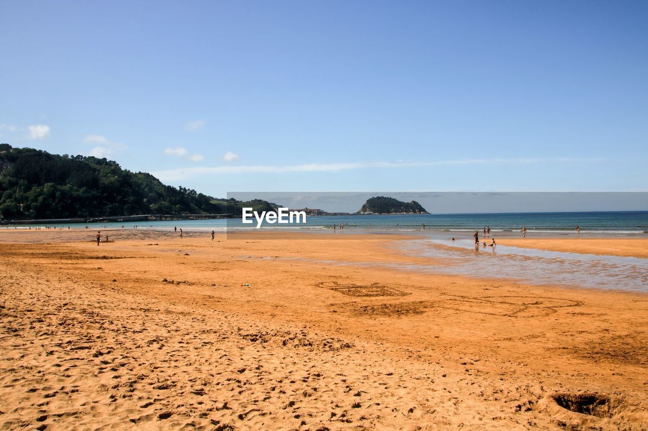 Scenic view of beach against blue sky