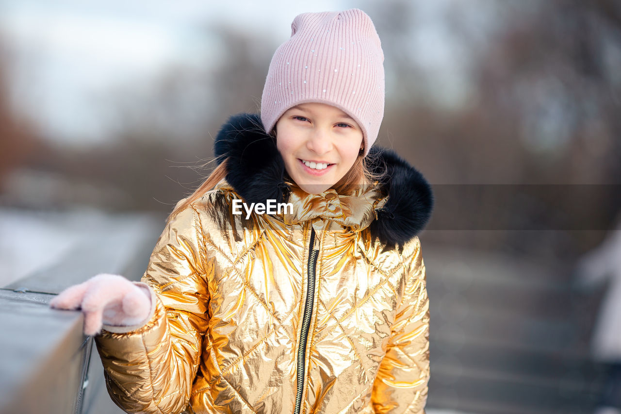 Portrait of smiling woman standing outdoors