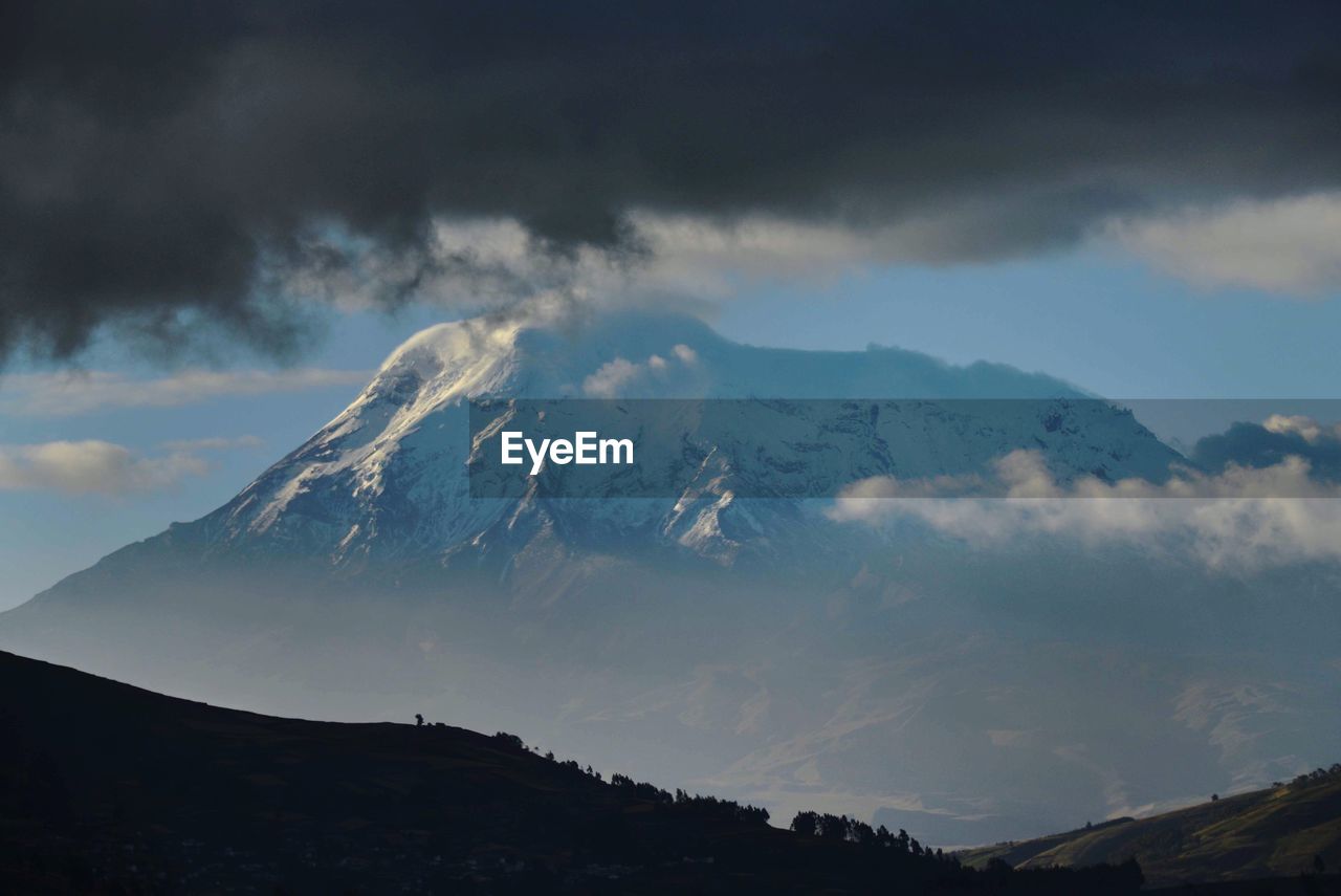 Low angle view of snowcapped mountain against sky