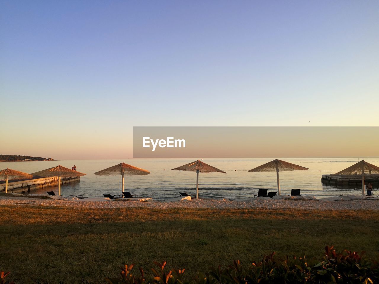 Scenic view of sea against clear sky during sunset