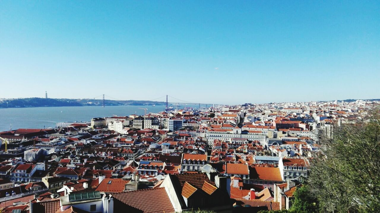 Aerial view of city against blue sky