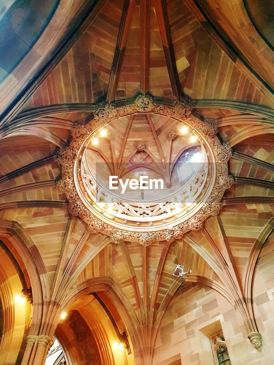 LOW ANGLE VIEW OF ILLUMINATED LIGHTS HANGING FROM CEILING