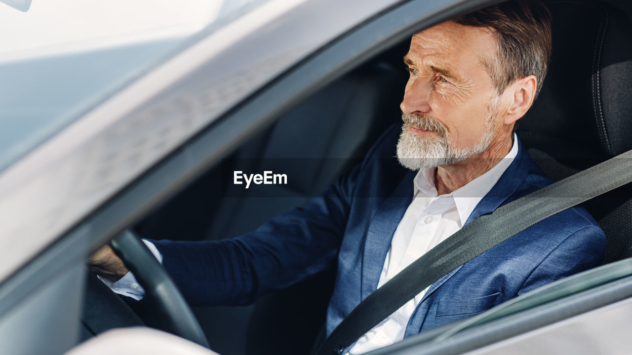 Businessman driving car