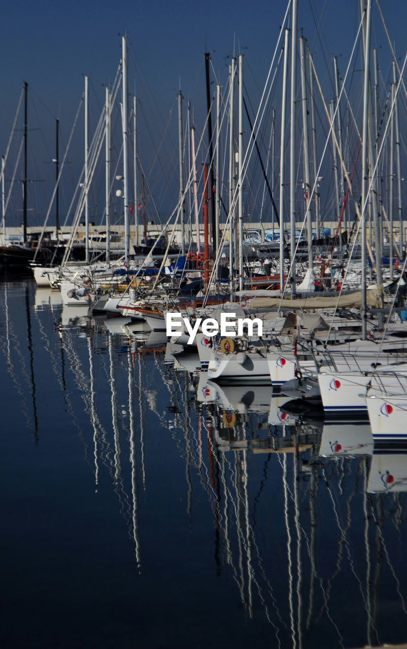 BOATS MOORED AT HARBOR