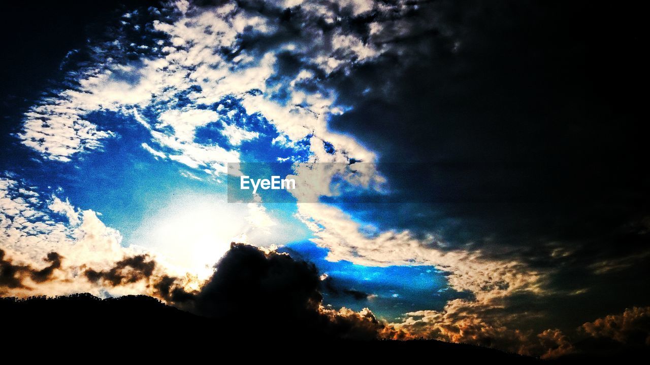 LOW ANGLE VIEW OF SKY OVER SILHOUETTE LANDSCAPE
