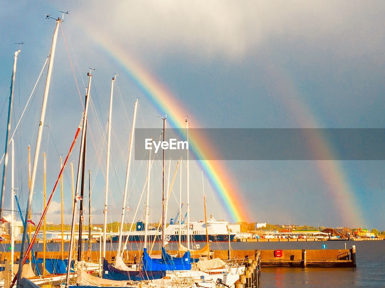 Scenic view of rainbow over sea against sky