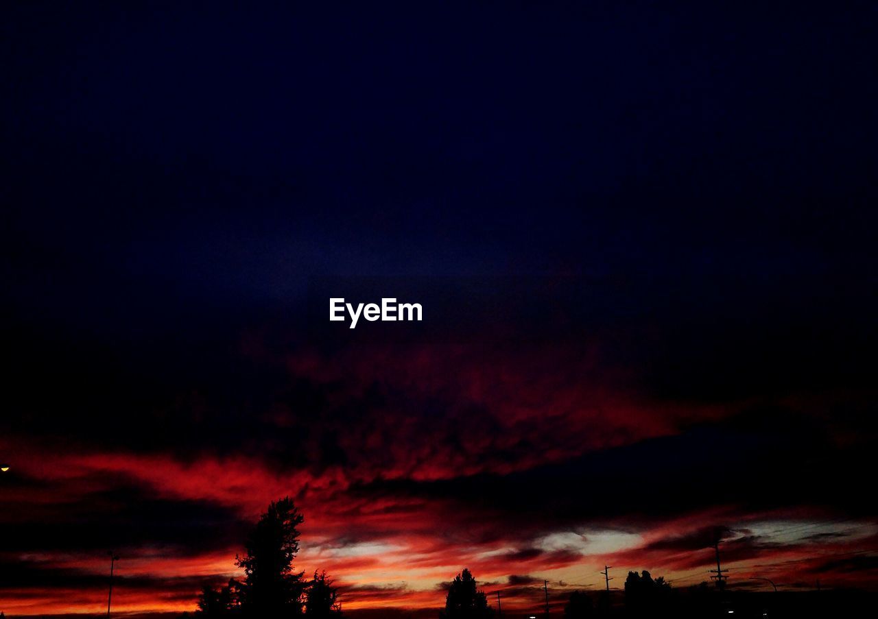 HIGH SECTION OF SILHOUETTE LANDSCAPE AGAINST DRAMATIC SKY