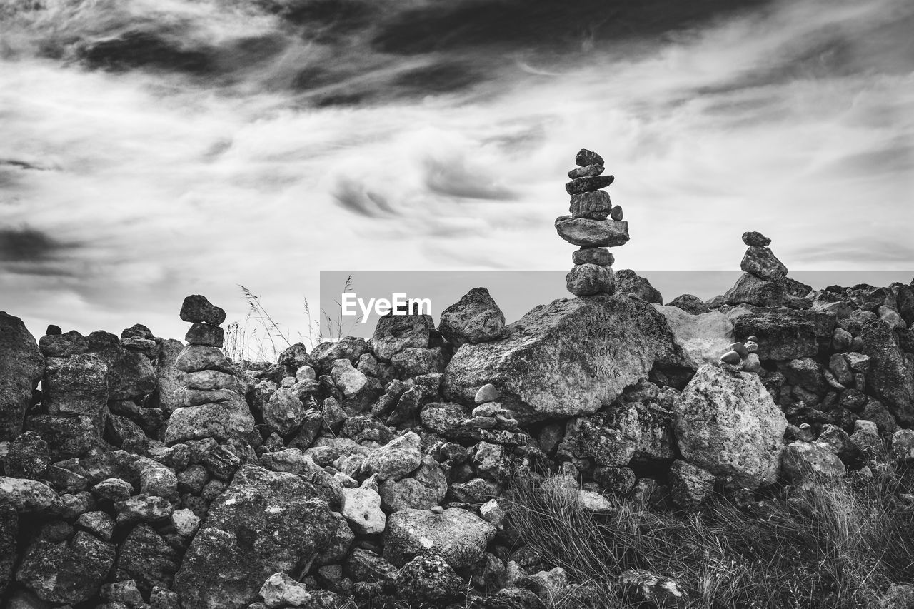 LOW ANGLE VIEW OF STACK AGAINST ROCKS AGAINST SKY