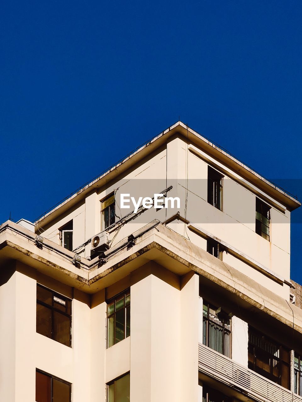 Low angle view of building against clear blue sky