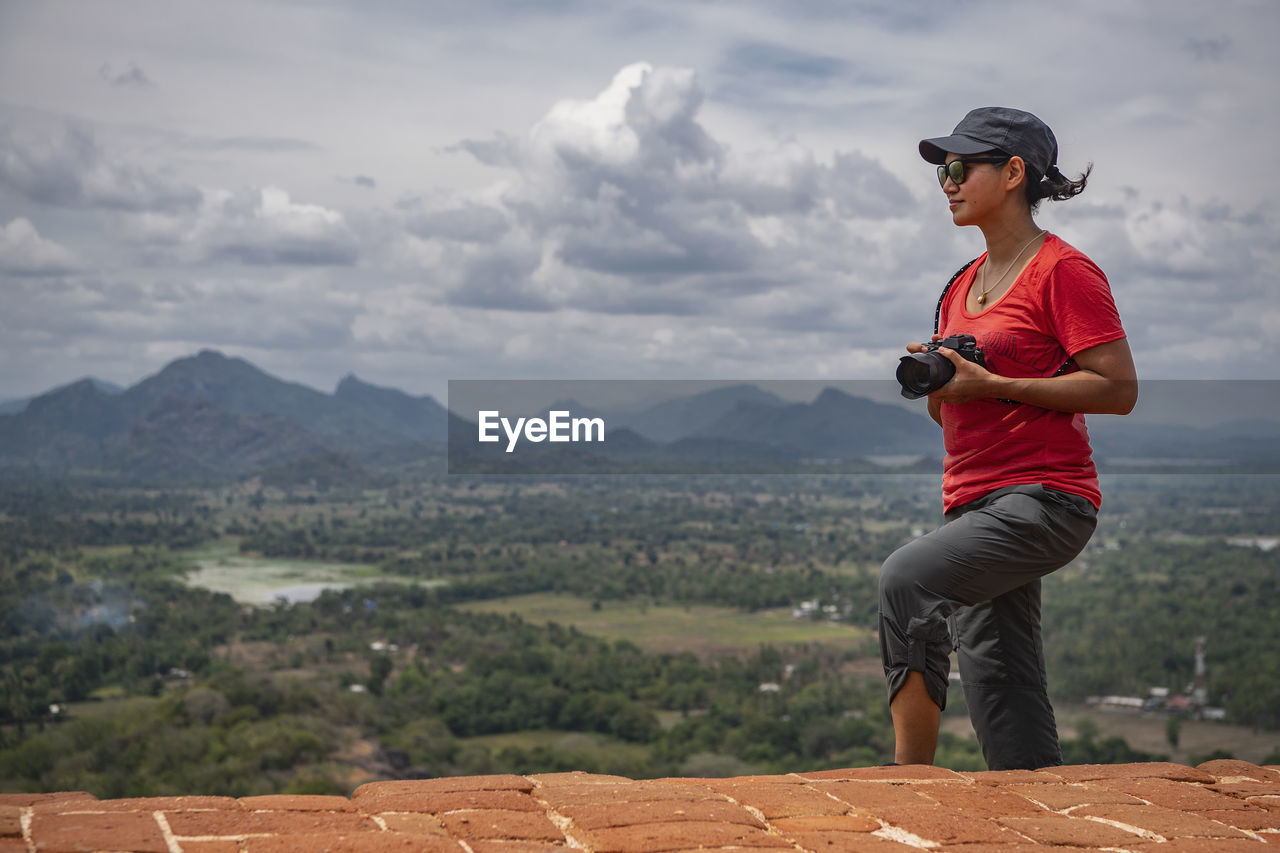 Woman taking picture on the top of the rock fortress of sigiriya