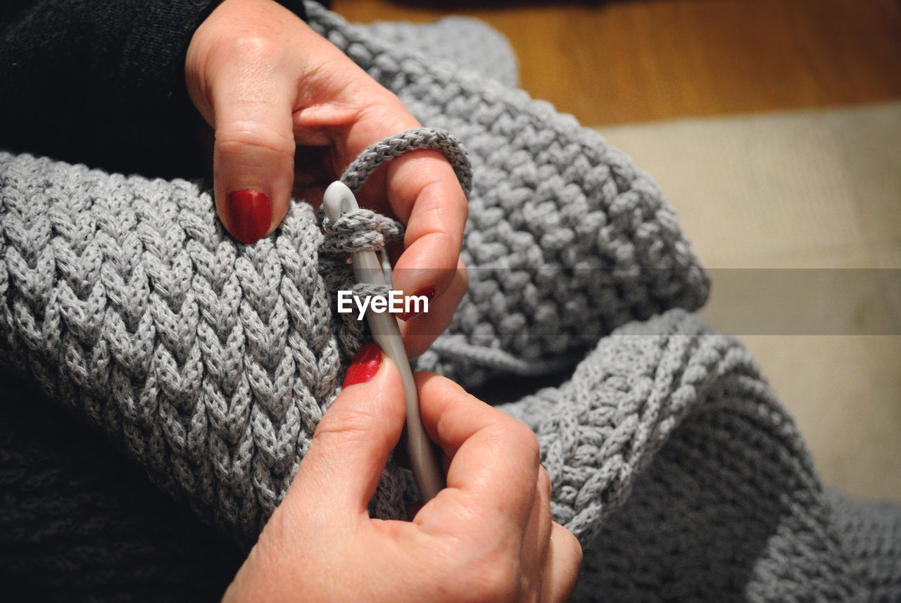 Close-up of woman weaving sweater