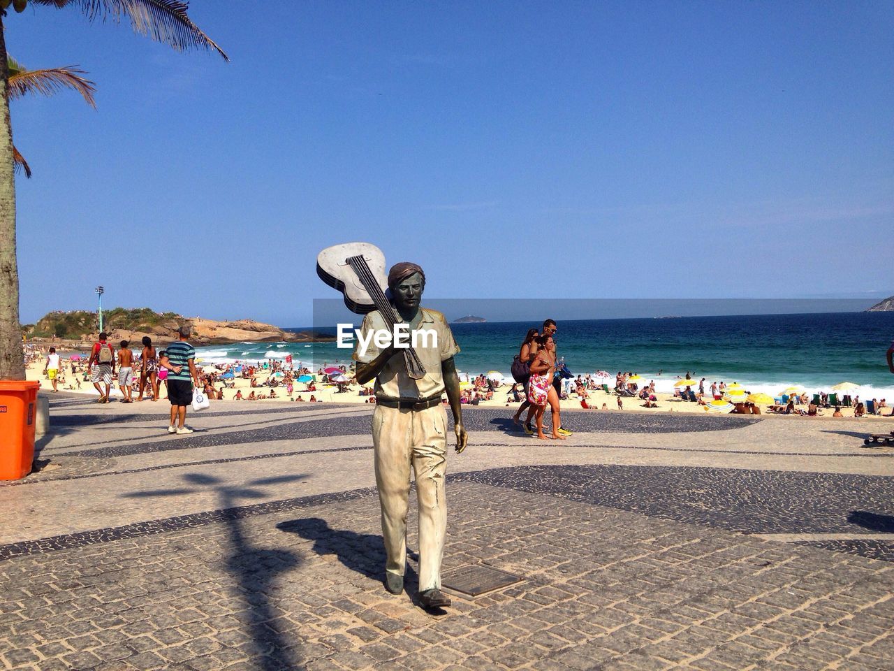 PEOPLE AT BEACH AGAINST SKY