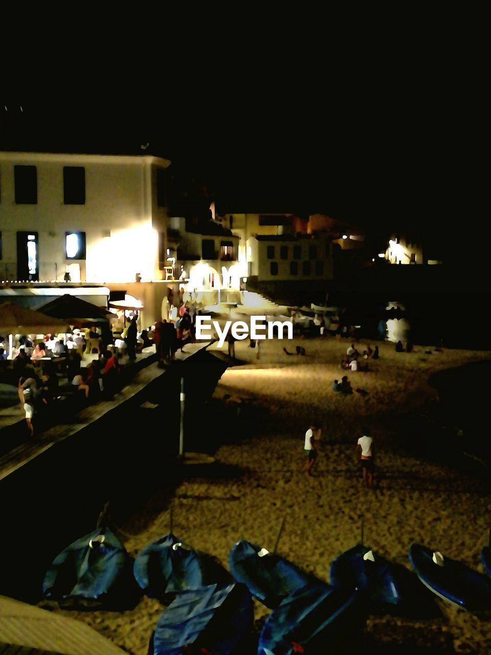 VIEW OF ILLUMINATED CITY STREET AT NIGHT